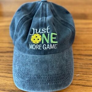 Wadeal Men’s Baseball Cap. It states on the cap
“just One More Game Adj Band